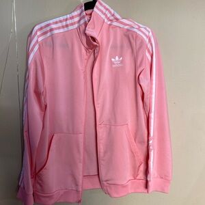 This is a pinkish-coral Adidas jacket that’s pink and white